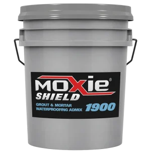A 5-gallon gray plastic bucket labeled "Moxie Shield 1900 – Grout & Mortar Waterproofing Admix," featuring a black label with white and red logo text