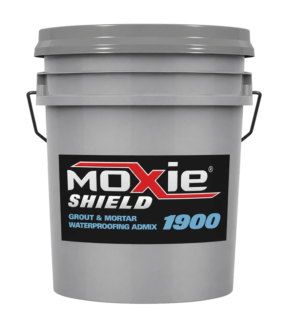 A 5-gallon gray plastic bucket labeled "Moxie Shield 1900 – Grout & Mortar Waterproofing Admix," featuring a black label with white and red logo text